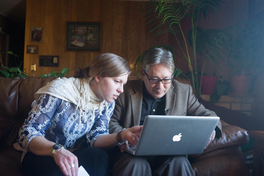 Graduate student Jayme Dittmar looks at old photos with Karma Tensum, Executive Director of the Tibetan Children’s Education Foundation. 