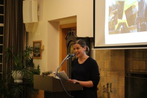 Derworiz standing in front of the audience answering questions.