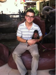 photo of Peregrine Frissell holding a small monkey.